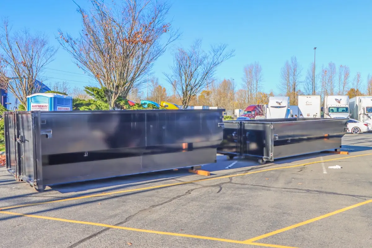 Professional dumpster rental service with roll-off container on residential driveway in Two Rivers